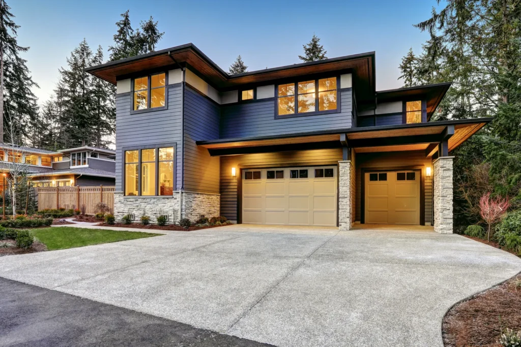 Contemporary two-story luxury home framed by mature evergreen trees